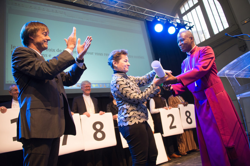 France's special envoy for the protection of the planet Nicolás Hulot (left) applauds as Archbishop Thabo Makgoba of South Africa presents Christiana Figueres, Executive Secretary of the United Nations Framework Convention on Climate Change, with some 1.8 million signatures on an interfaith petition for climate justice during the COP21 climate summit in Paris, France, November 28, 2015.